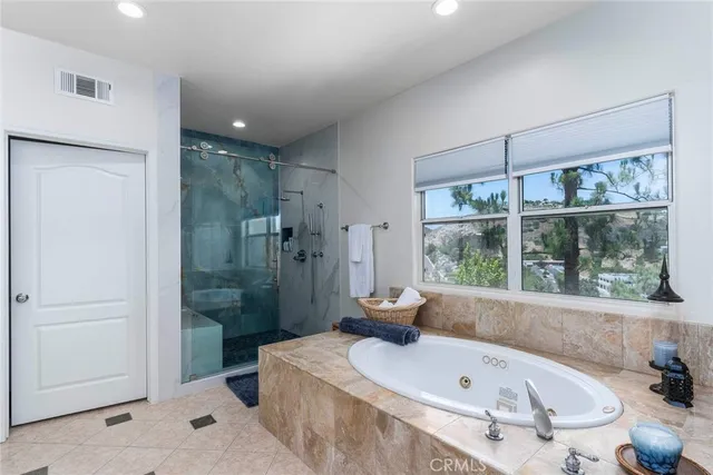 a bathroom with a tub sink and shower