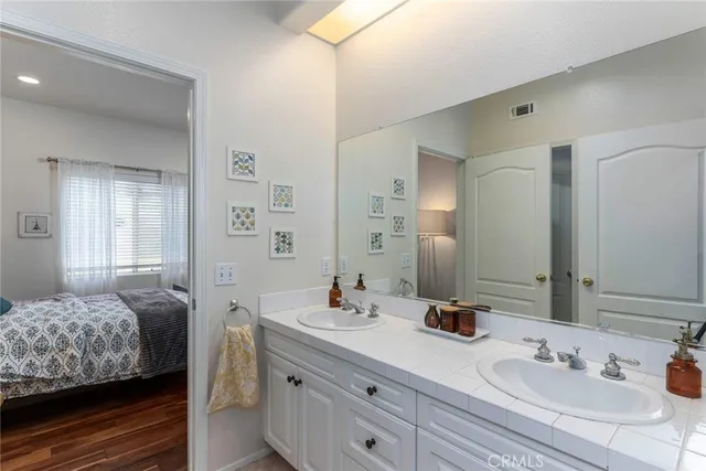 a bathroom with a sink double vanity and a mirror