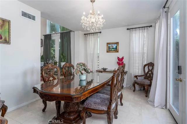 a view of a dining room with furniture and chandelier
