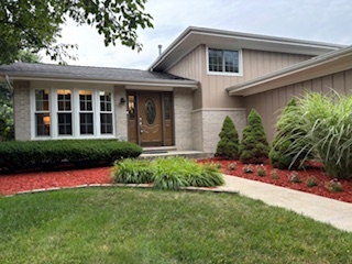 a front view of a house with a yard and porch