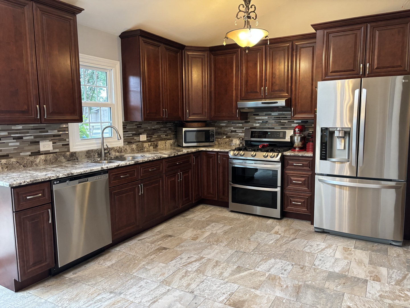 16529 Edgewood Road Plainfield, IL 60586 - Photo 2 of 24 a kitchen with stainless steel appliances granite countertop a stove refrigerator and cabinets