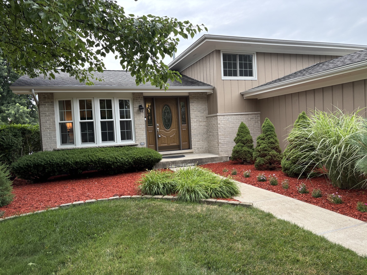 16529 Edgewood Road Plainfield, IL 60586 - Photo 23 of 24 a front view of a house with a yard and porch