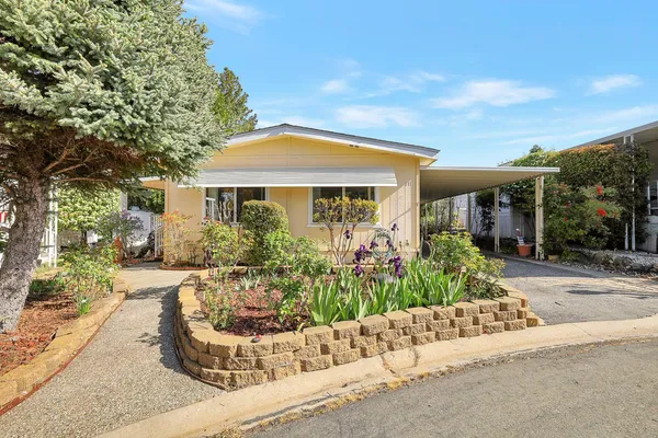 front view of a house with a bench