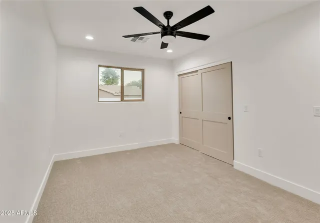 a dining room with furniture and a floor to ceiling window