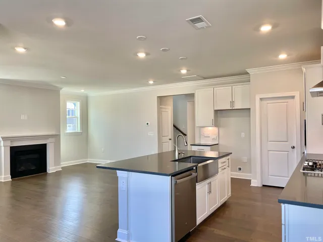 a kitchen with stainless steel appliances a stove top oven a sink and a refrigerator