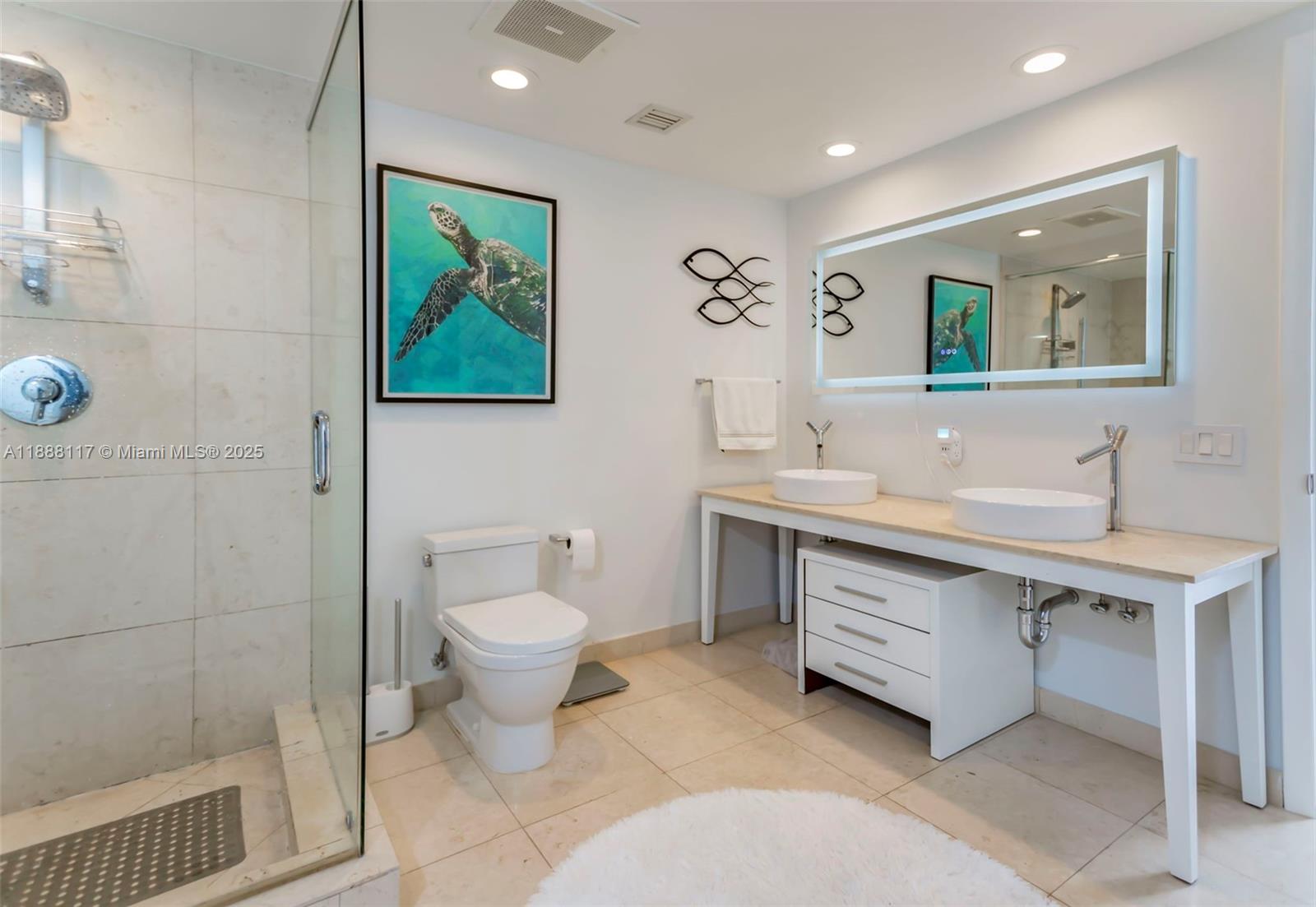 485 Brickell Avenue, Unit 2502 Miami, FL 33131 - Photo 13 of 24 a bathroom with a sink mirror and toilet