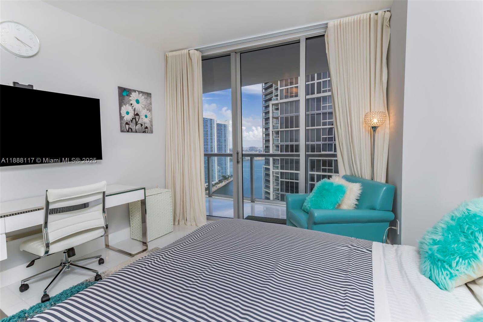 485 Brickell Avenue, Unit 2502 Miami, FL 33131 - Photo 15 of 24 a bedroom with a bed and a flat screen tv