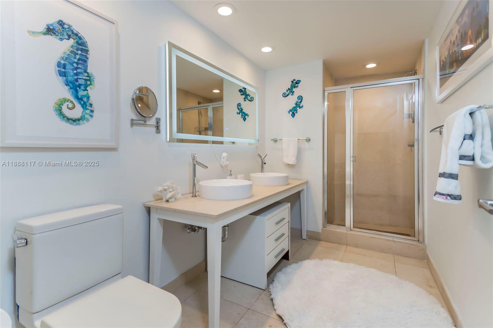 485 Brickell Avenue, Unit 2502 Miami, FL 33131 - Photo 17 of 24 a bathroom with a sink a toilet and shower