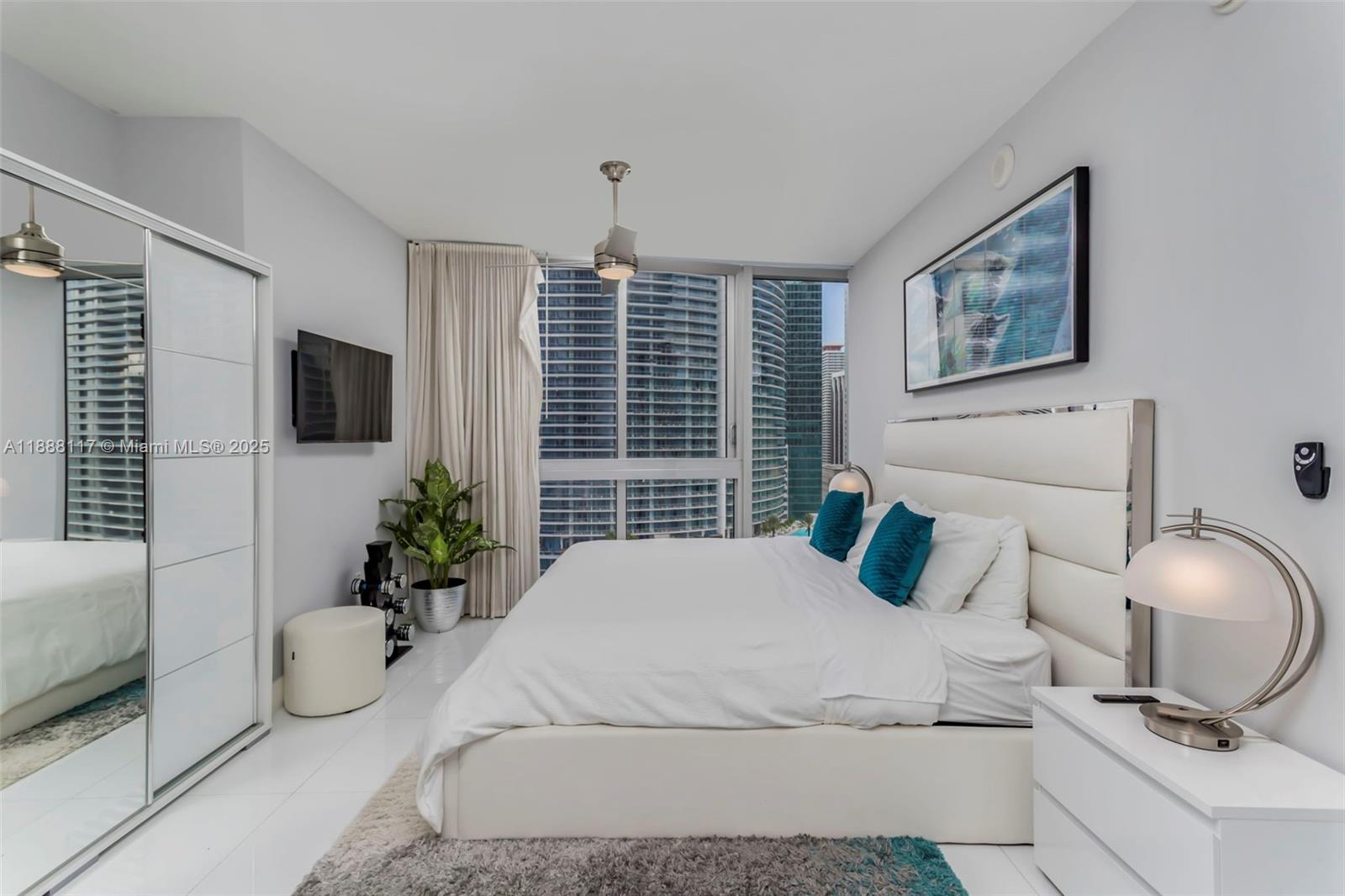 485 Brickell Avenue, Unit 2502 Miami, FL 33131 - Photo 10 of 24 a bedroom with a bed potted plant and a window