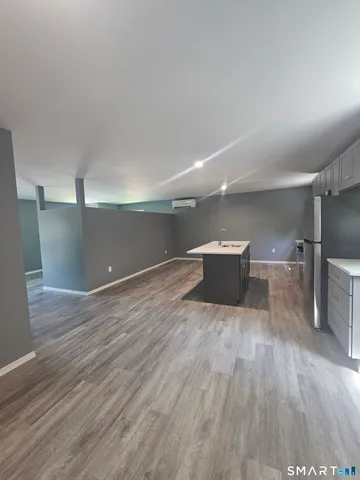 a view of a room with wooden floor