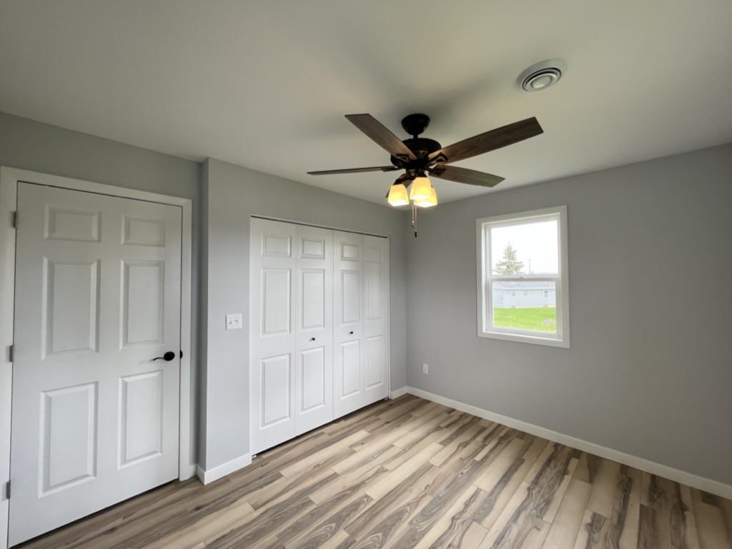 35 Field Road Silver Bay, MN 55614 - Photo 15 of 20 Unfurnished bedroom with light wood finished floors, a closet, and ceiling fan