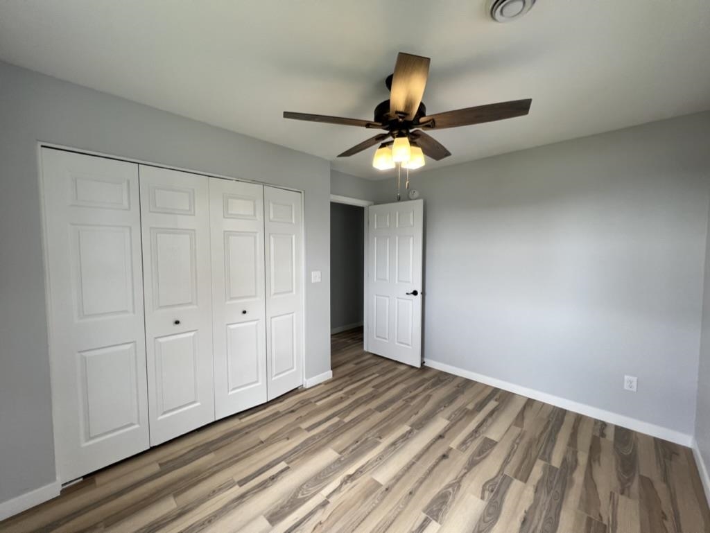 35 Field Road Silver Bay, MN 55614 - Photo 16 of 20 Unfurnished bedroom with light wood-style flooring, a closet, and a ceiling fan
