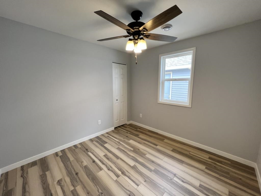35 Field Road Silver Bay, MN 55614 - Photo 18 of 20 Empty room with light wood-style floors and ceiling fan