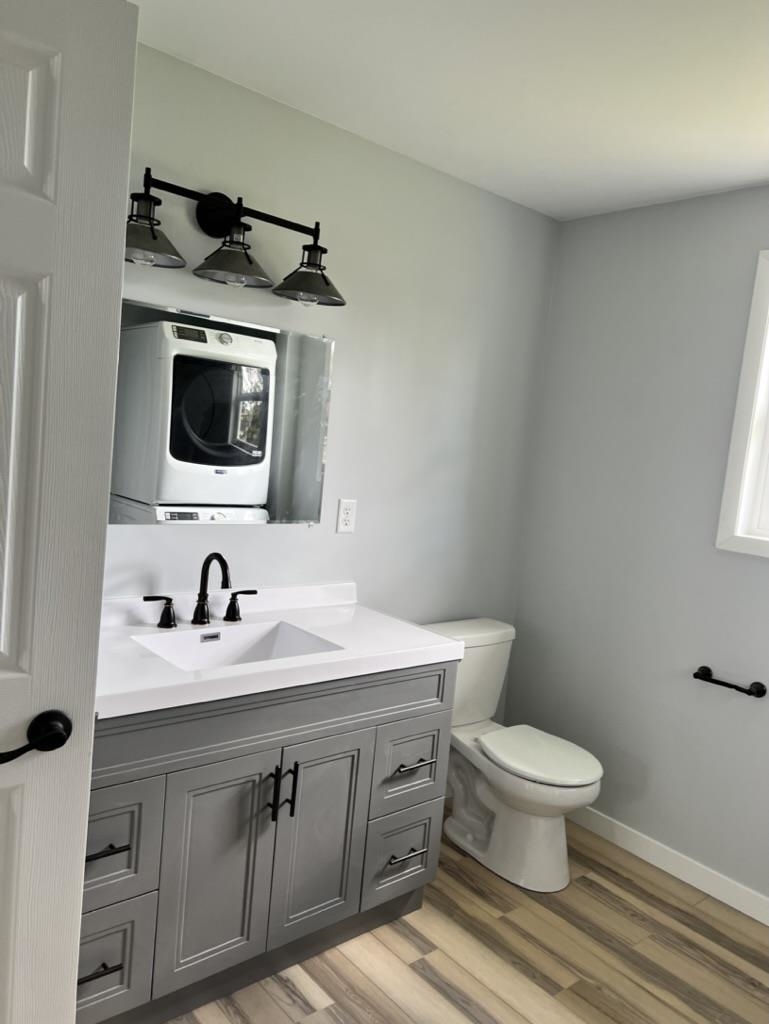 35 Field Road Silver Bay, MN 55614 - Photo 10 of 20 Bathroom with light wood-style floors, vanity, and stacked washer / dryer
