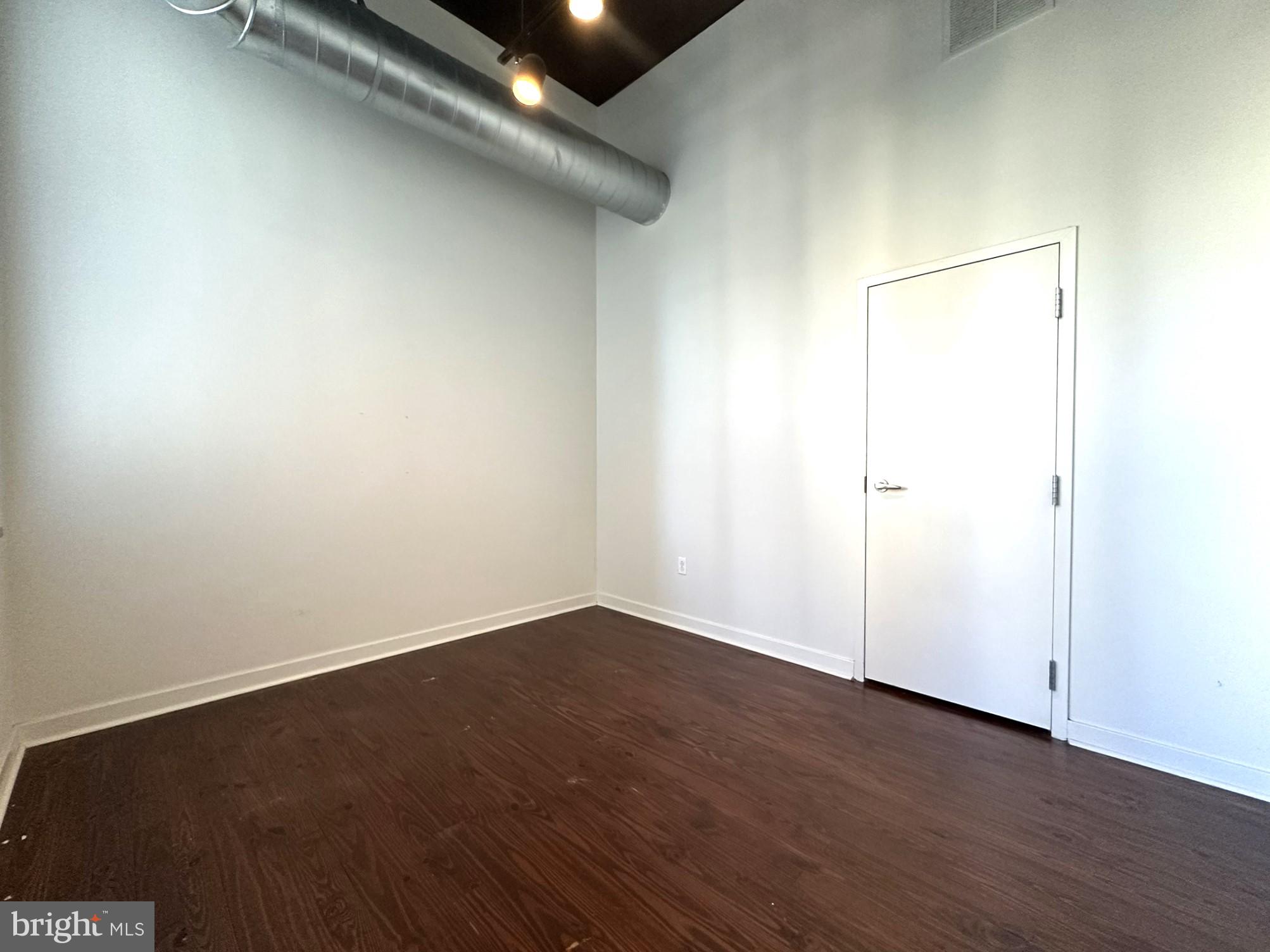 1510 Chestnut Street, Unit 902 Philadelphia, PA 19102 - Photo 13 of 19 an empty room with wooden floor