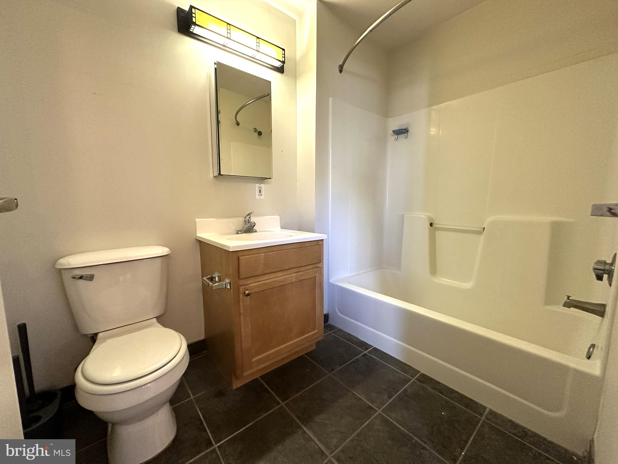 1510 Chestnut Street, Unit 902 Philadelphia, PA 19102 - Photo 16 of 19 a bathroom with a toilet a sink and bathtub