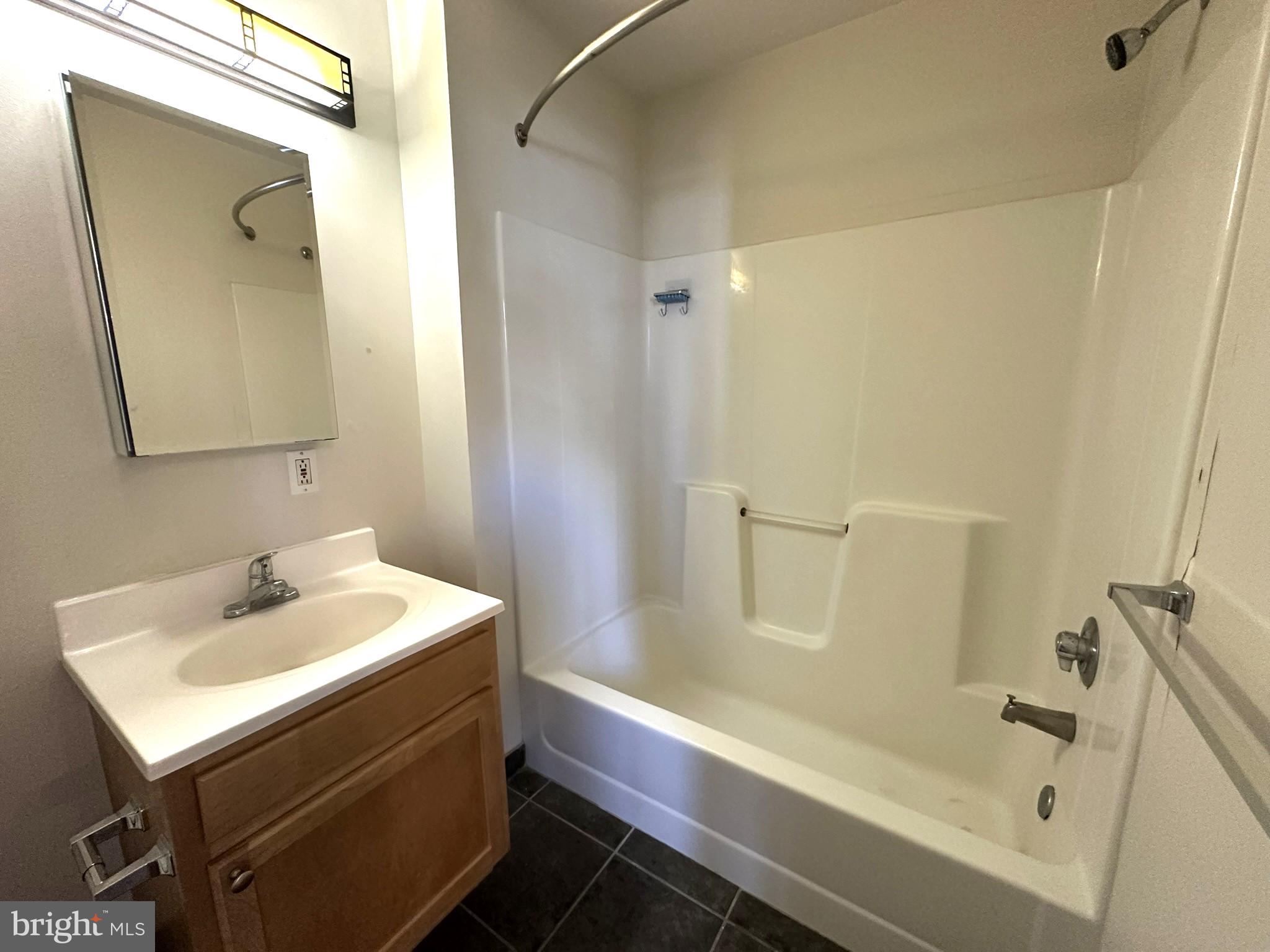 1510 Chestnut Street, Unit 902 Philadelphia, PA 19102 - Photo 18 of 19 a bathroom with a sink a toilet and shower
