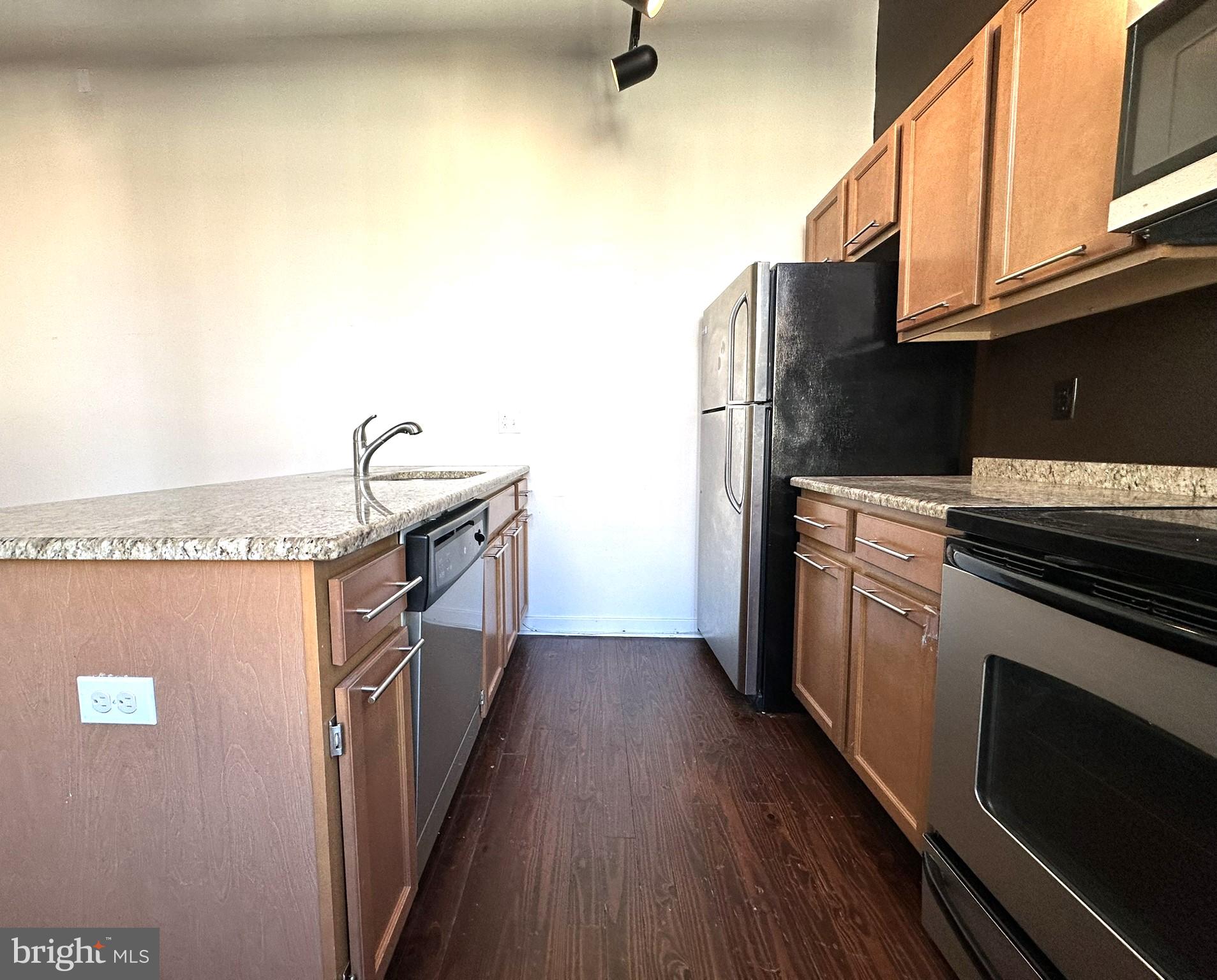 1510 Chestnut Street, Unit 902 Philadelphia, PA 19102 - Photo 9 of 19 a kitchen with stainless steel appliances granite countertop a stove a sink and a refrigerator