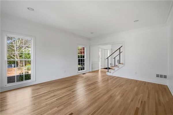 a view of entryway livingroom and hall with wooden floor