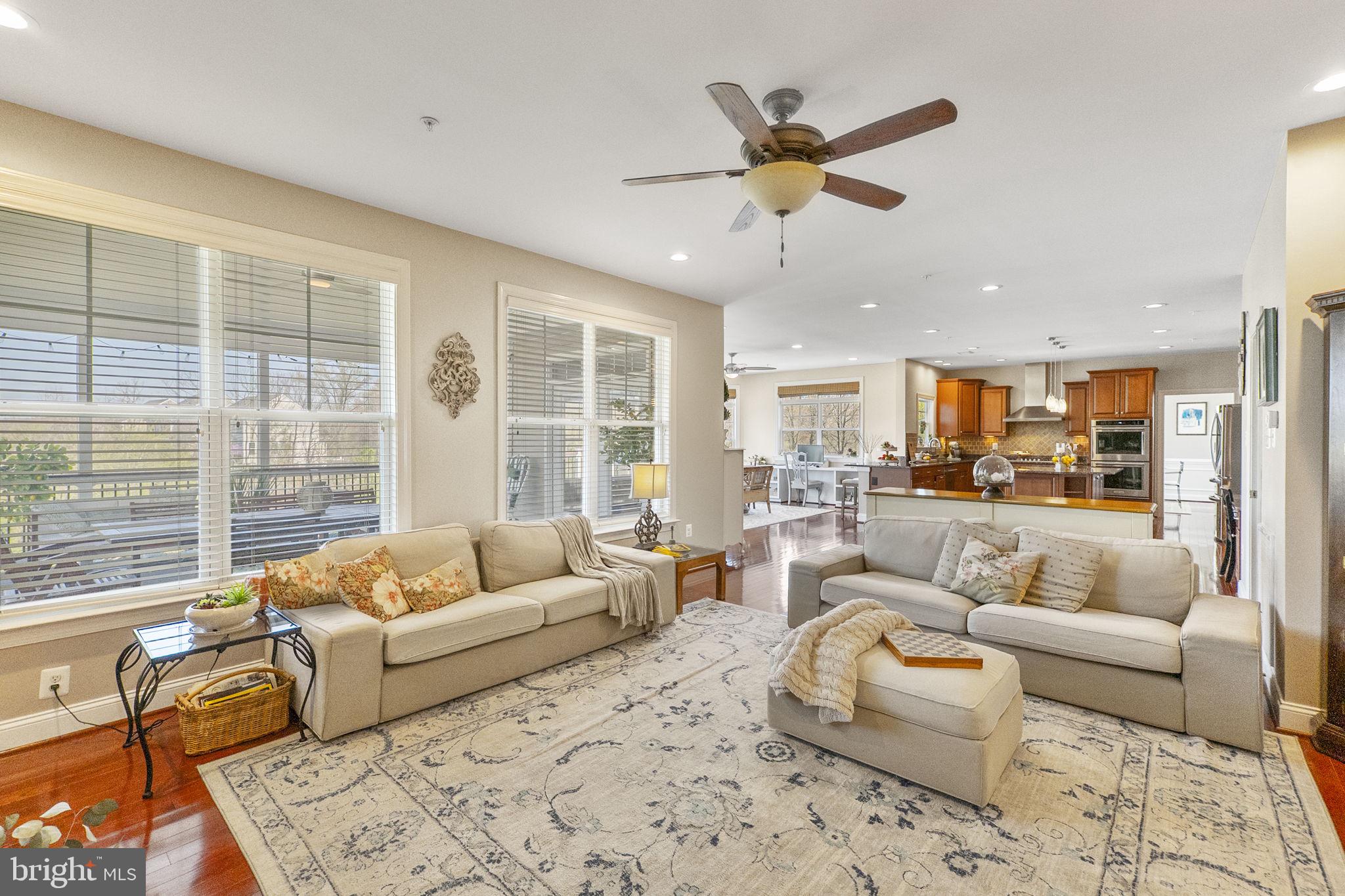 18004 Bliss Drive Poolesville, MD 20837 - Photo 12 of 57 a living room with furniture and a large window with kitchen view
