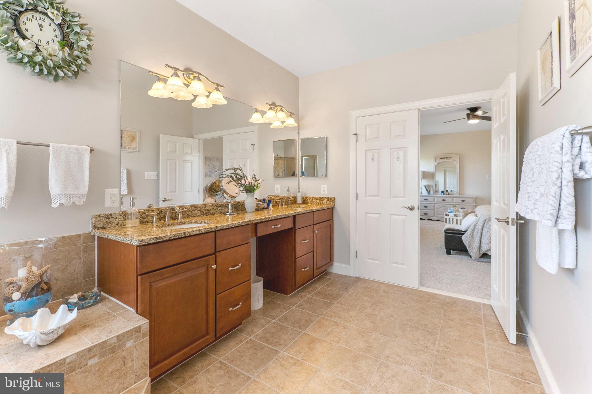 18004 Bliss Drive Poolesville, MD 20837 - Photo 22 of 57 a spacious bathroom with a double vanity sink mirror and