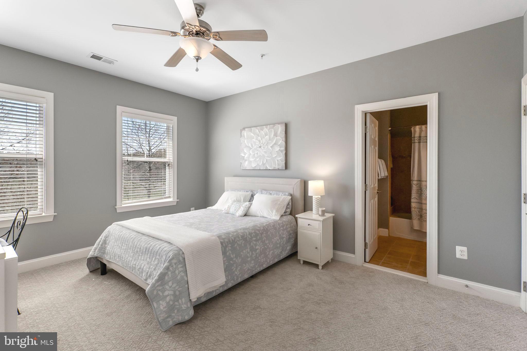 18004 Bliss Drive Poolesville, MD 20837 - Photo 23 of 57 a bedroom with a bed and a chandelier