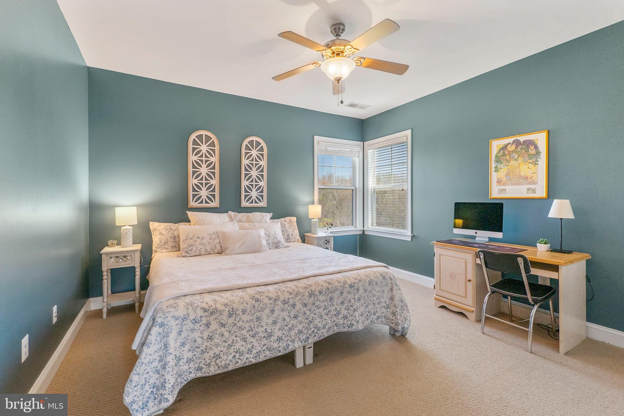 18004 Bliss Drive Poolesville, MD 20837 - Photo 26 of 57 a bedroom with a bed and a chandelier