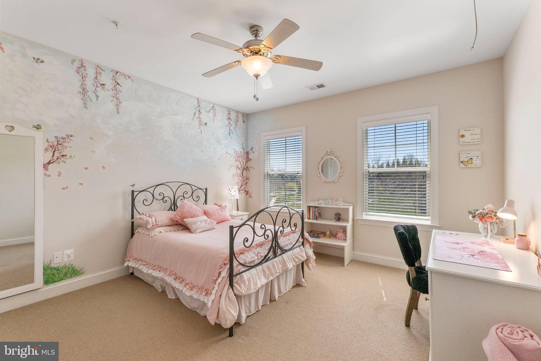 18004 Bliss Drive Poolesville, MD 20837 - Photo 27 of 57 a bedroom with a bed and a chandelier