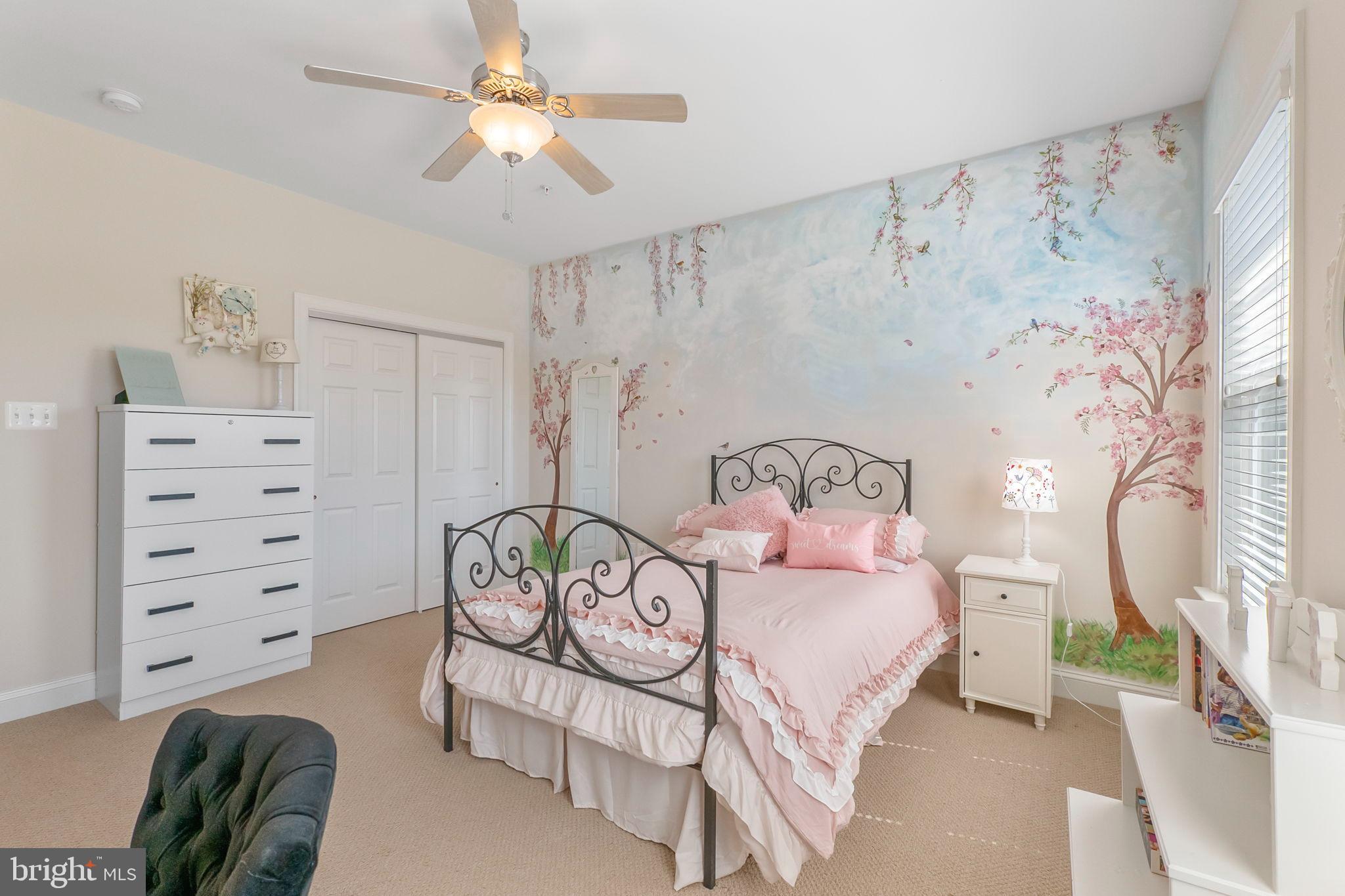 18004 Bliss Drive Poolesville, MD 20837 - Photo 28 of 57 a bedroom with a bed and a chandelier