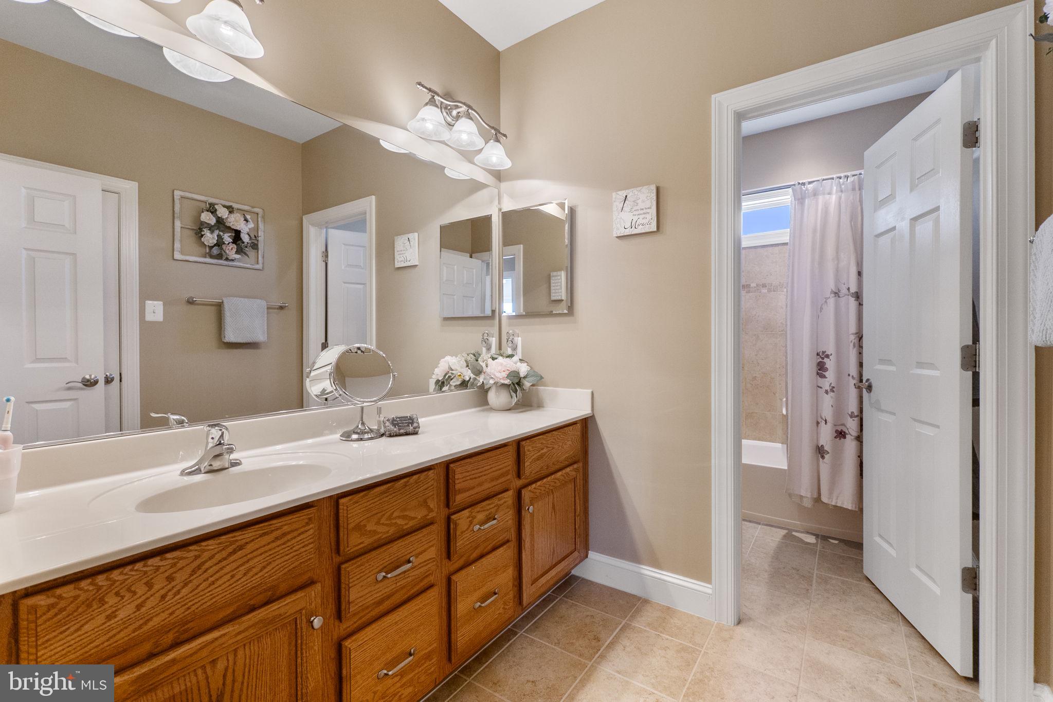 18004 Bliss Drive Poolesville, MD 20837 - Photo 29 of 57 a bathroom with a double vanity sink shower and a mirror