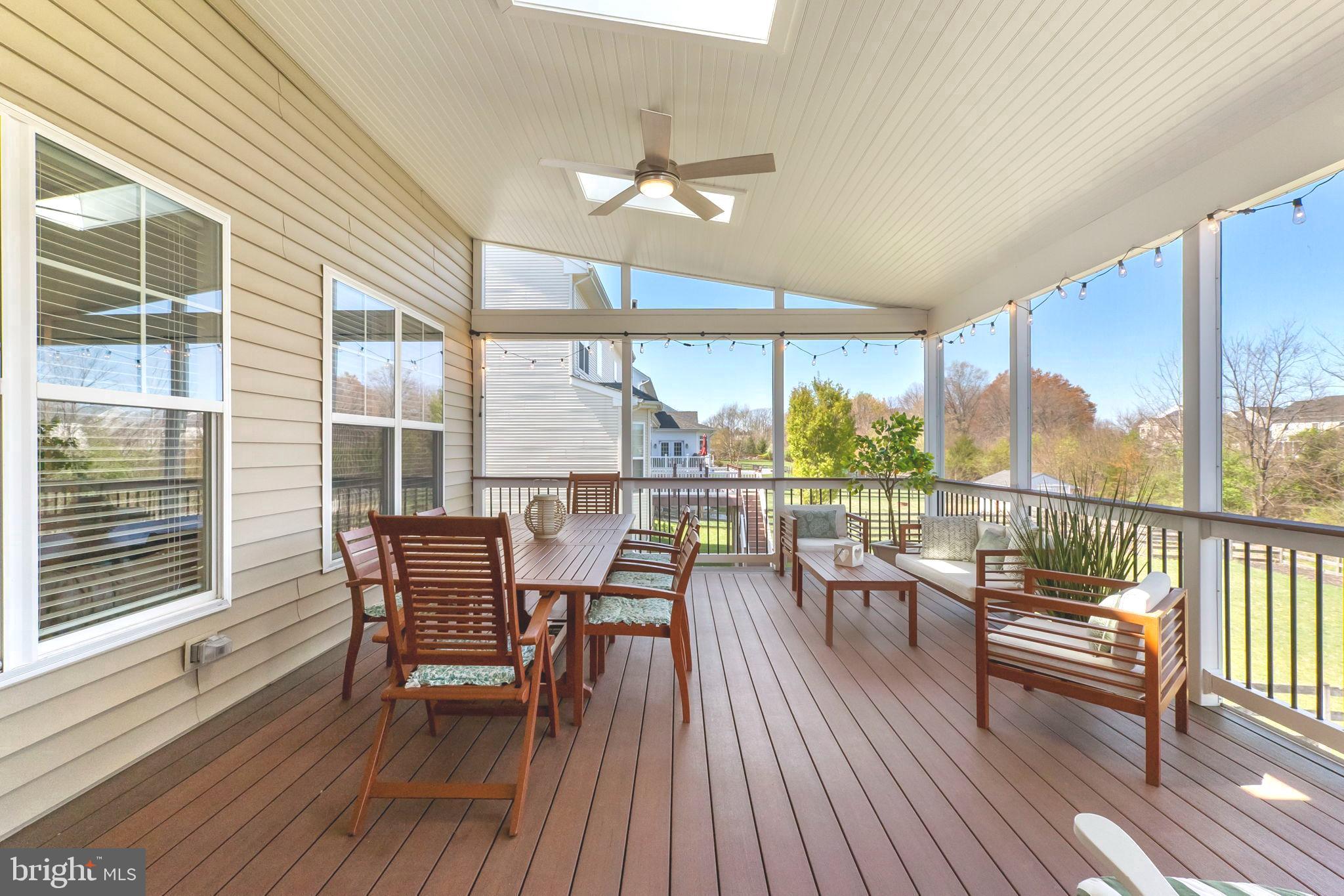 18004 Bliss Drive Poolesville, MD 20837 - Photo 34 of 57 a dining room with furniture large windows and wooden floor