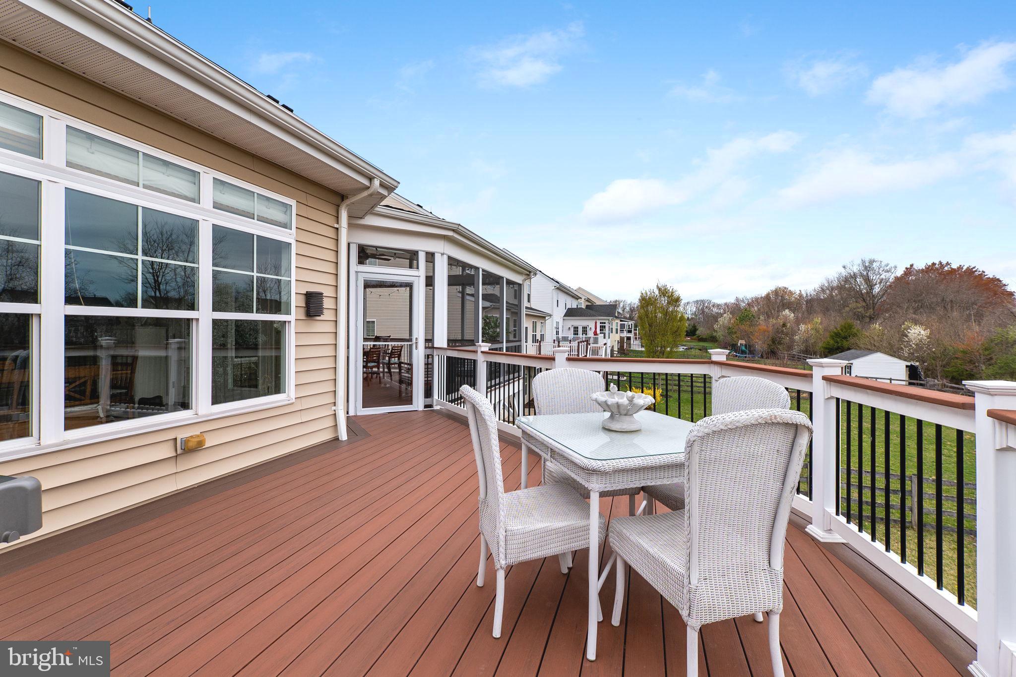 18004 Bliss Drive Poolesville, MD 20837 - Photo 36 of 57 a view of a balcony with a table and chairs