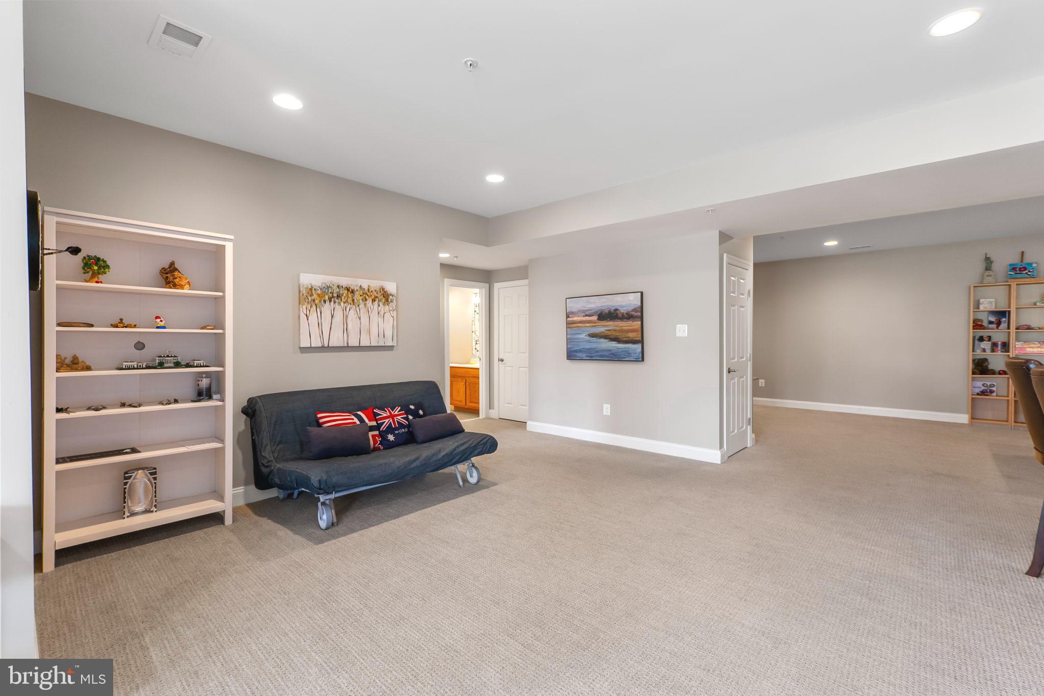 18004 Bliss Drive Poolesville, MD 20837 - Photo 40 of 57 a living room with furniture and a flat screen tv