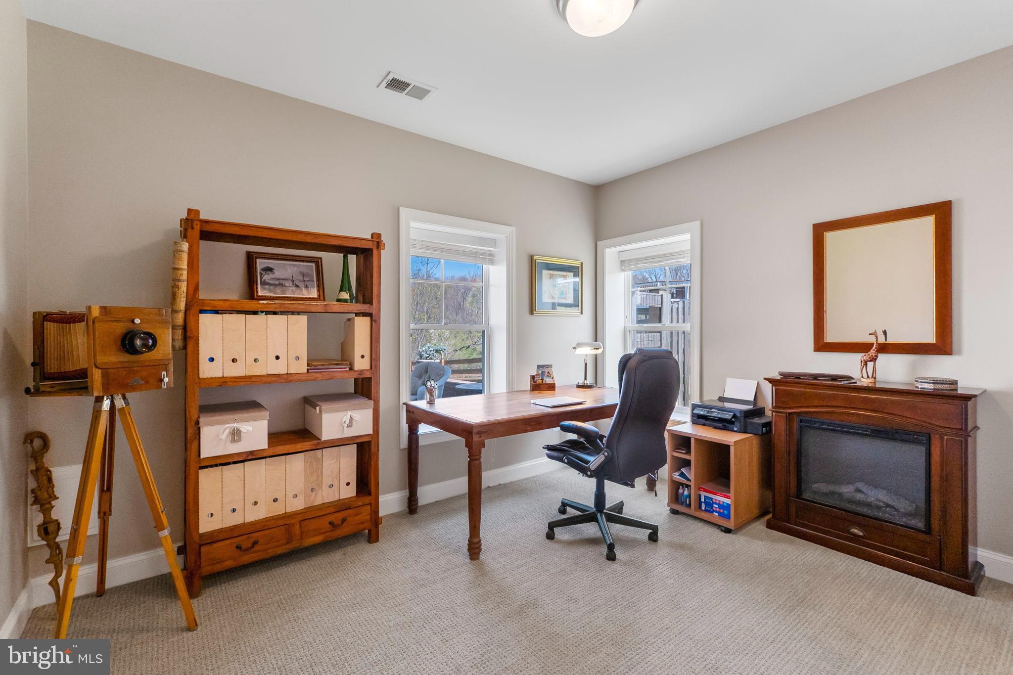 18004 Bliss Drive Poolesville, MD 20837 - Photo 42 of 57 a view of a livingroom with workspace and a fireplace