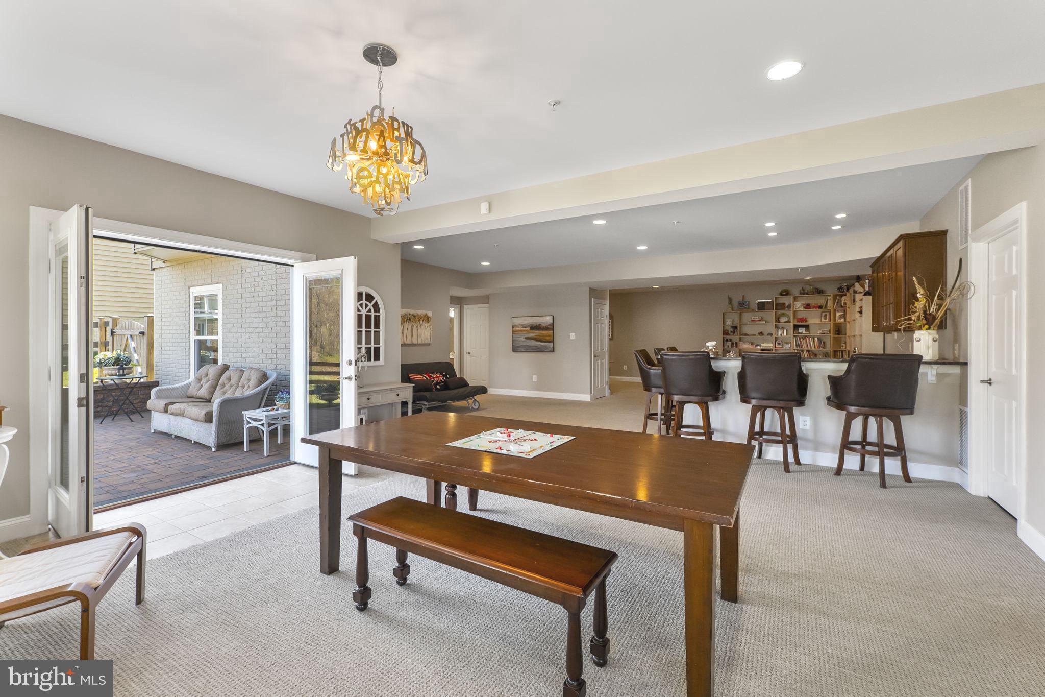 18004 Bliss Drive Poolesville, MD 20837 - Photo 45 of 57 a living room with furniture a table and a chandelier