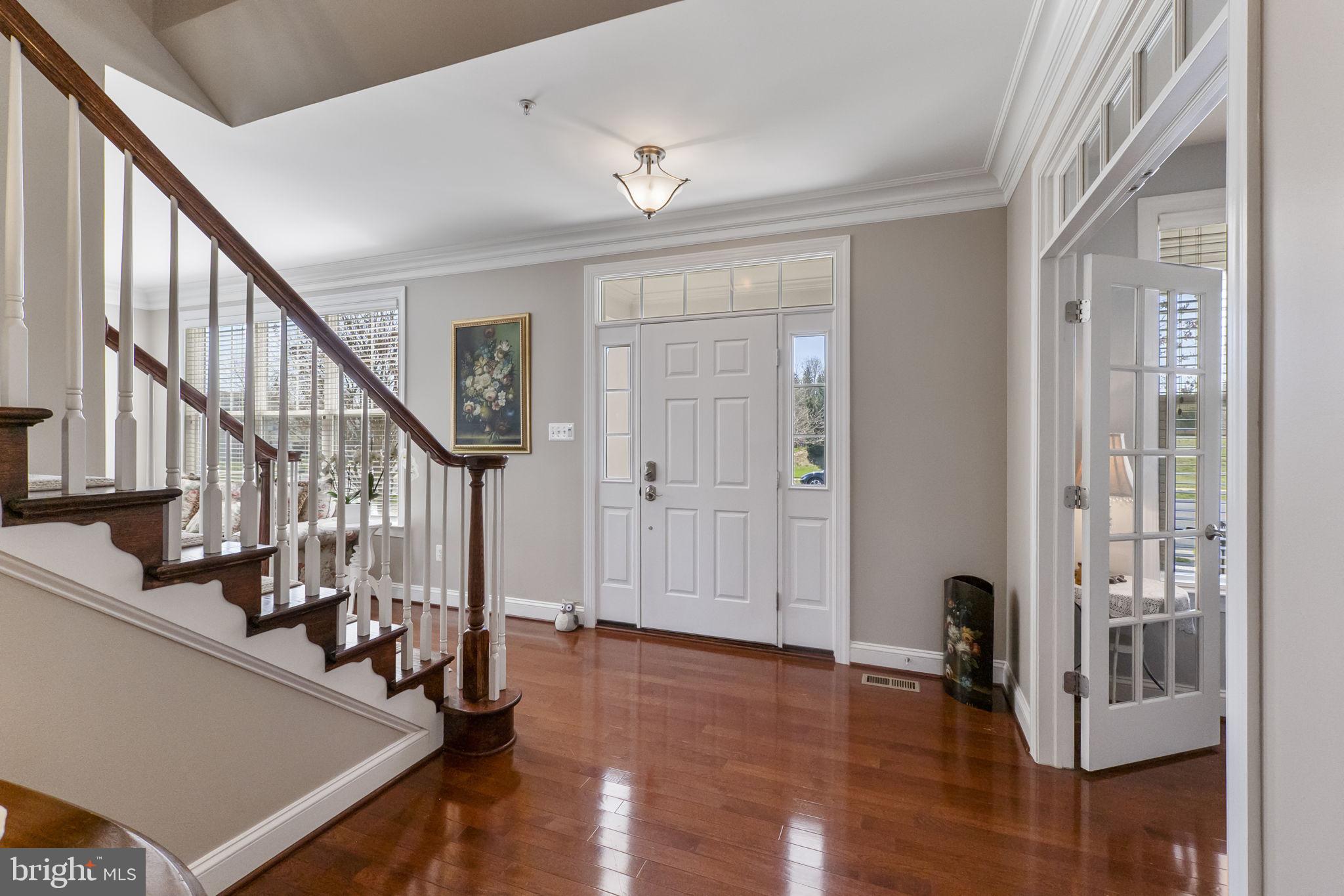 18004 Bliss Drive Poolesville, MD 20837 - Photo 6 of 57 a view of a livingroom with wooden floor and stairs