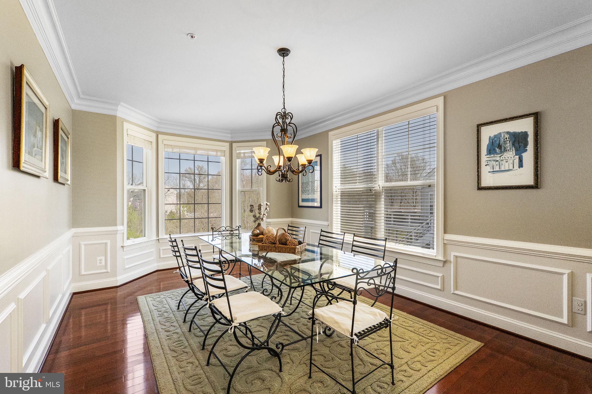 18004 Bliss Drive Poolesville, MD 20837 - Photo 9 of 57 a dining room with furniture a chandelier and wooden floor