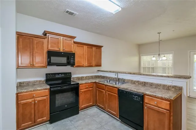 a kitchen with granite countertop stainless steel appliances and wooden cabinets