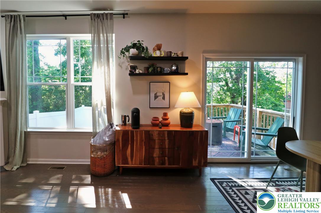4502 Benjamin Court Emmaus, PA 18049 - Photo 16 of 53 Warm wood flooring extends to a sliding glass door revealing an inviting outdoor deck space.