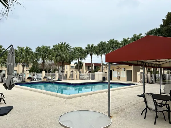 a view of a house with swimming pool and sitting area