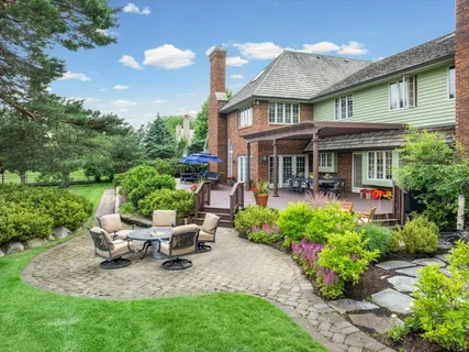 a view of a house with a yard and furniture
