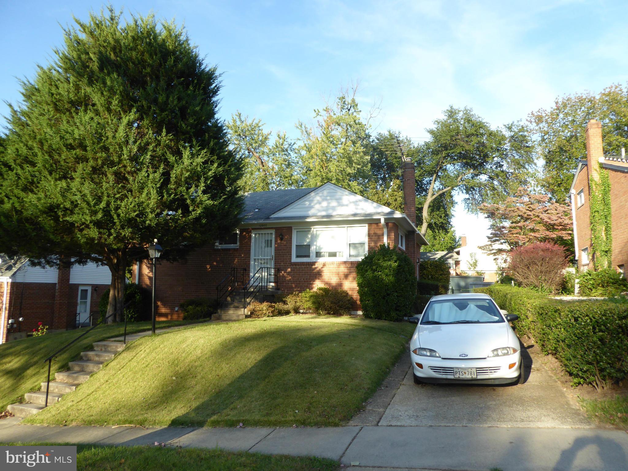 12907 Bluhill Road Silver Spring, MD 20906 - Photo 1 of 20 a front view of a house with a yard and trees