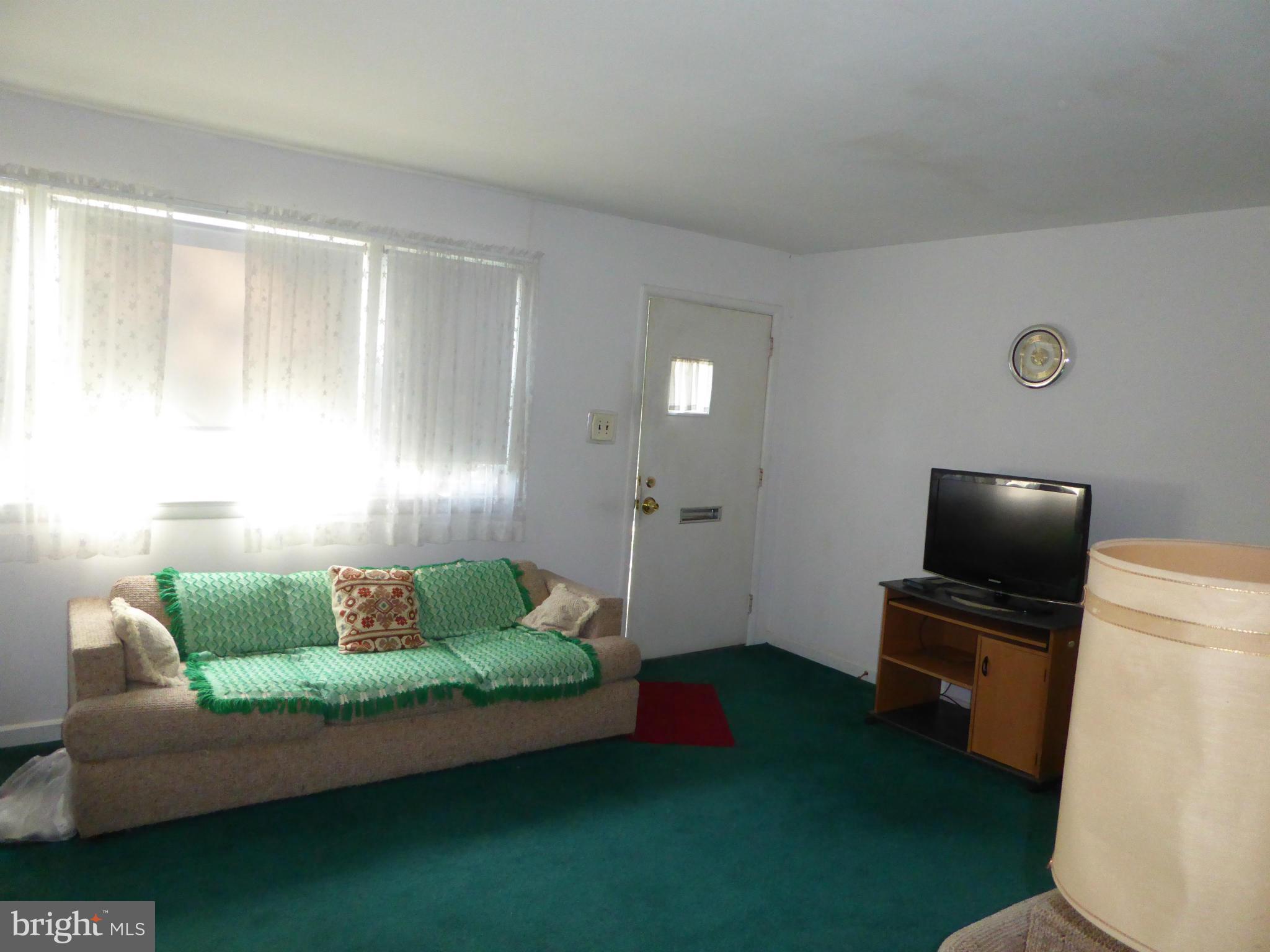 12907 Bluhill Road Silver Spring, MD 20906 - Photo 2 of 20 a living room with furniture and a flat screen tv