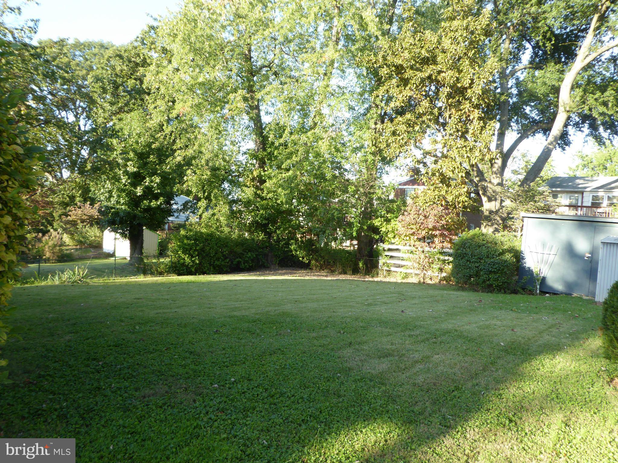12907 Bluhill Road Silver Spring, MD 20906 - Photo 18 of 20 a view of a grassy field with trees