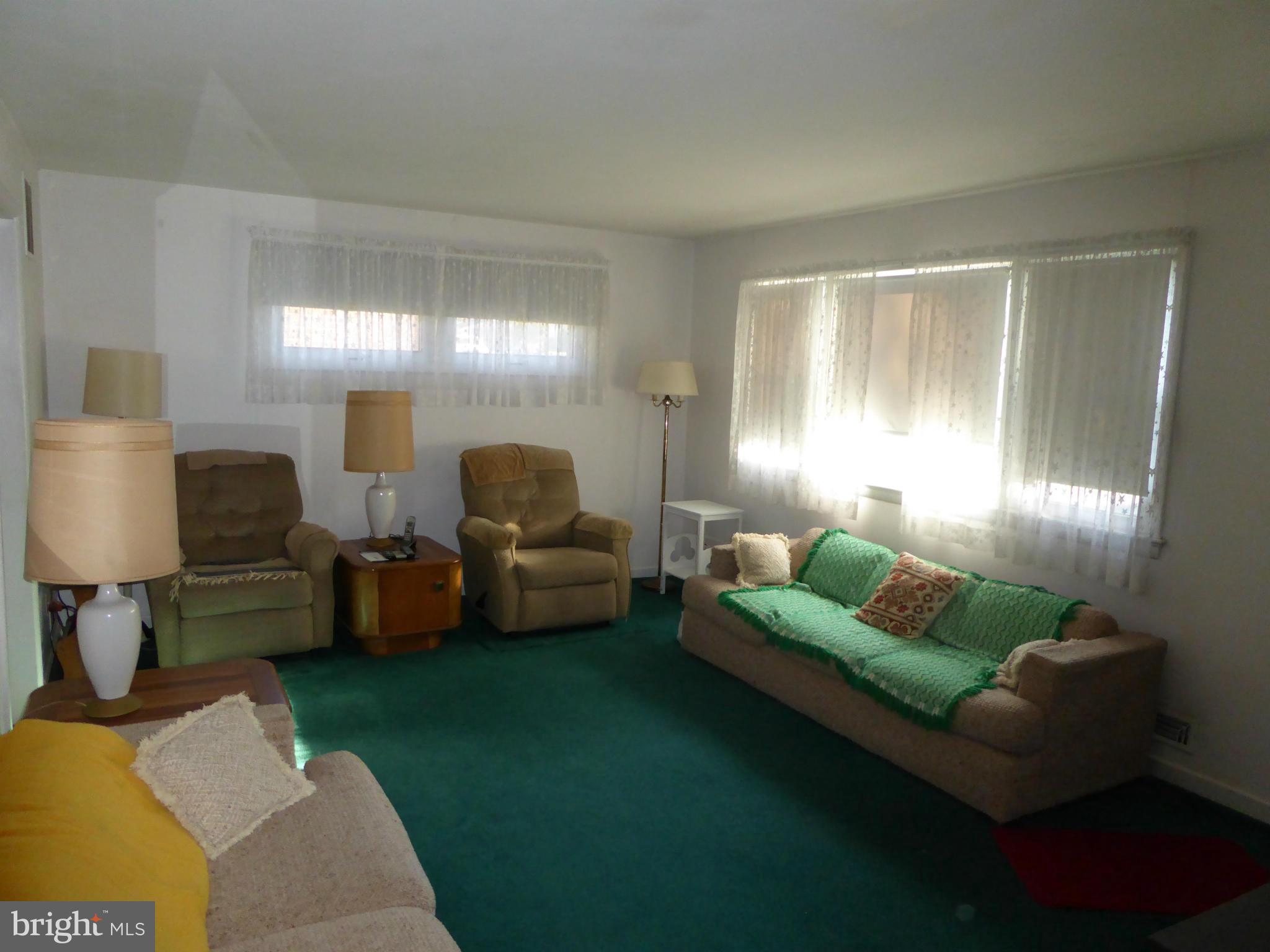 12907 Bluhill Road Silver Spring, MD 20906 - Photo 3 of 20 a living room with furniture and a lamp