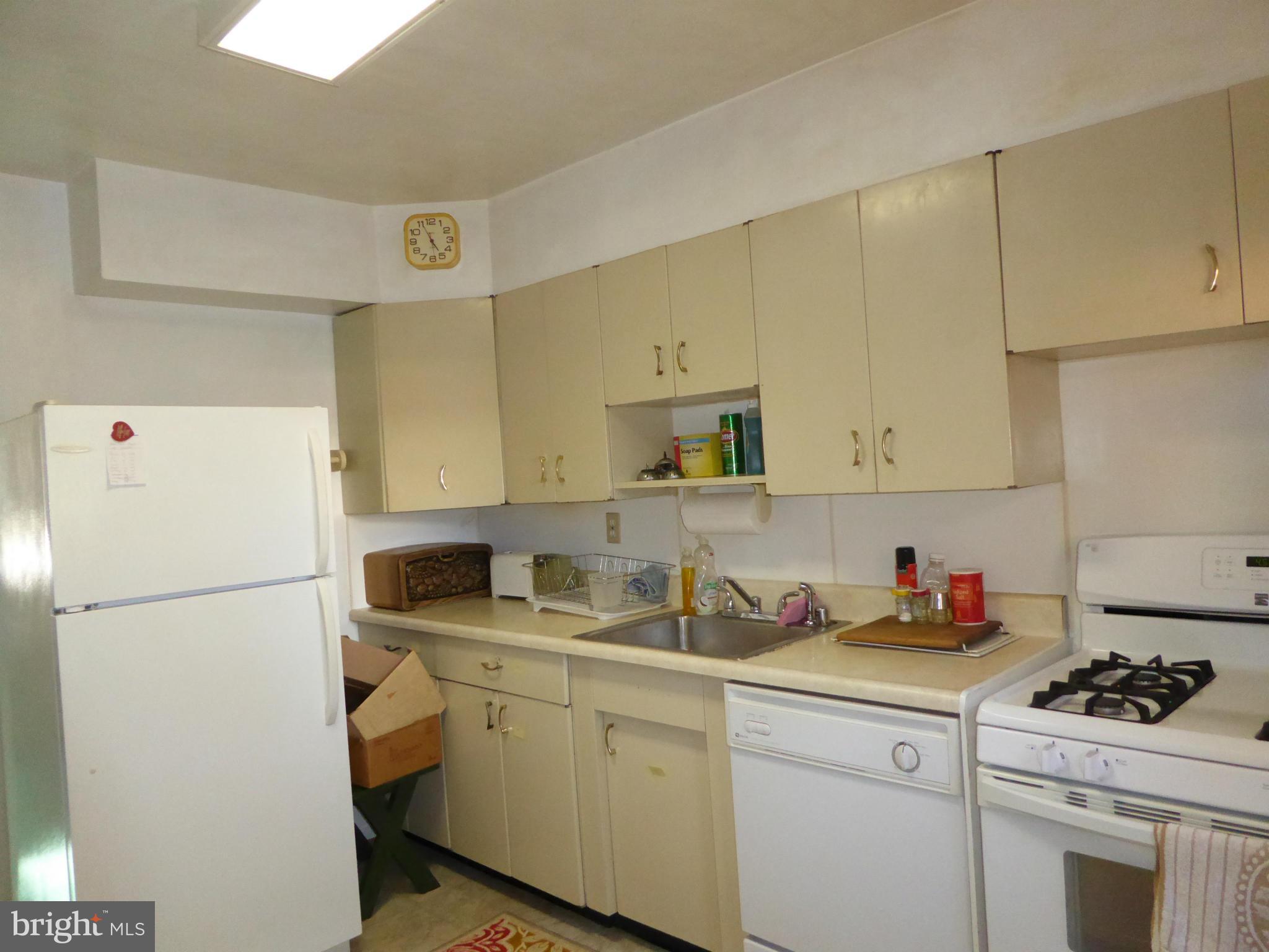 12907 Bluhill Road Silver Spring, MD 20906 - Photo 6 of 20 a kitchen with a sink stove and refrigerator