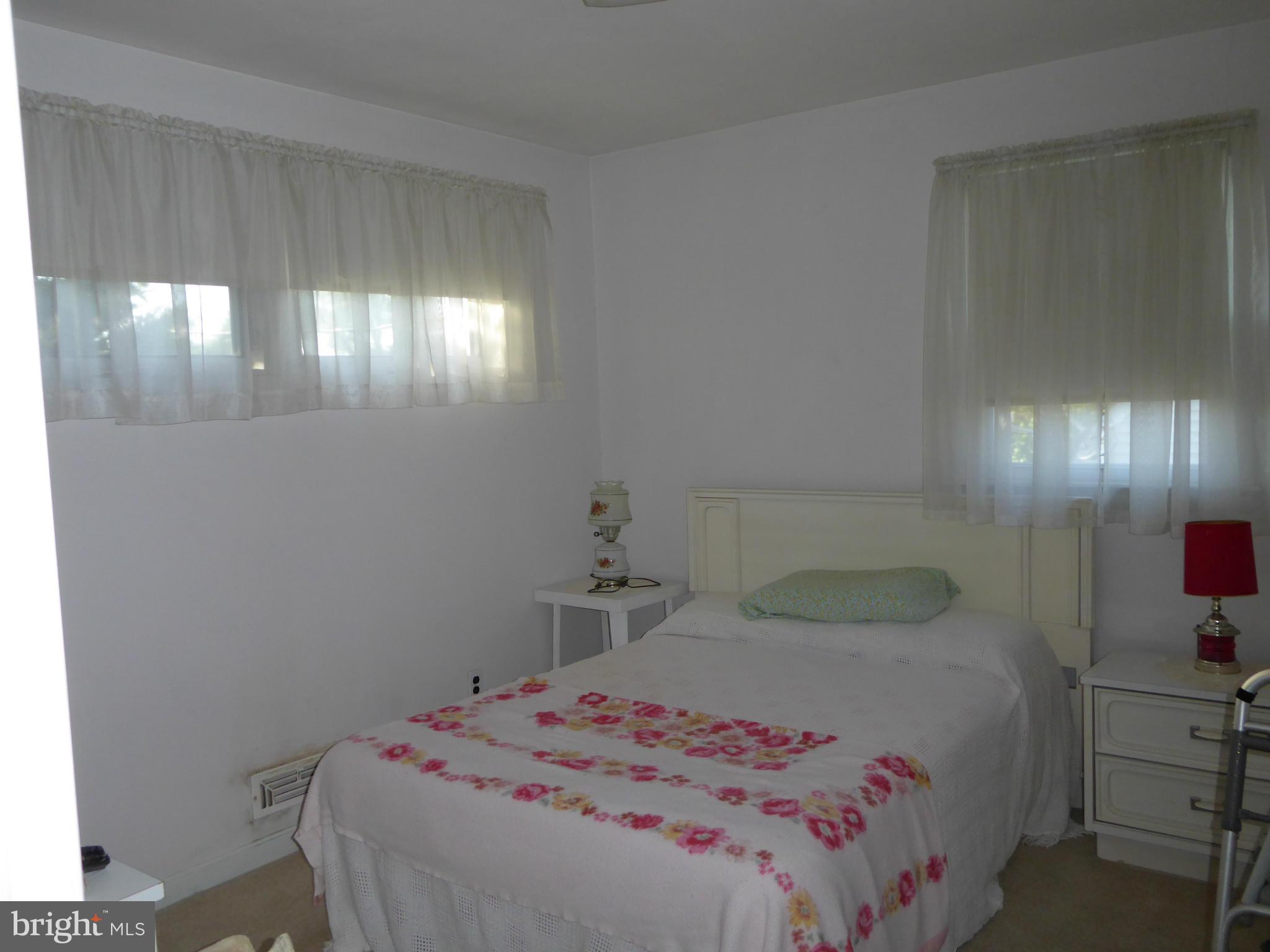 12907 Bluhill Road Silver Spring, MD 20906 - Photo 7 of 20 a bedroom with a bed and a night stand