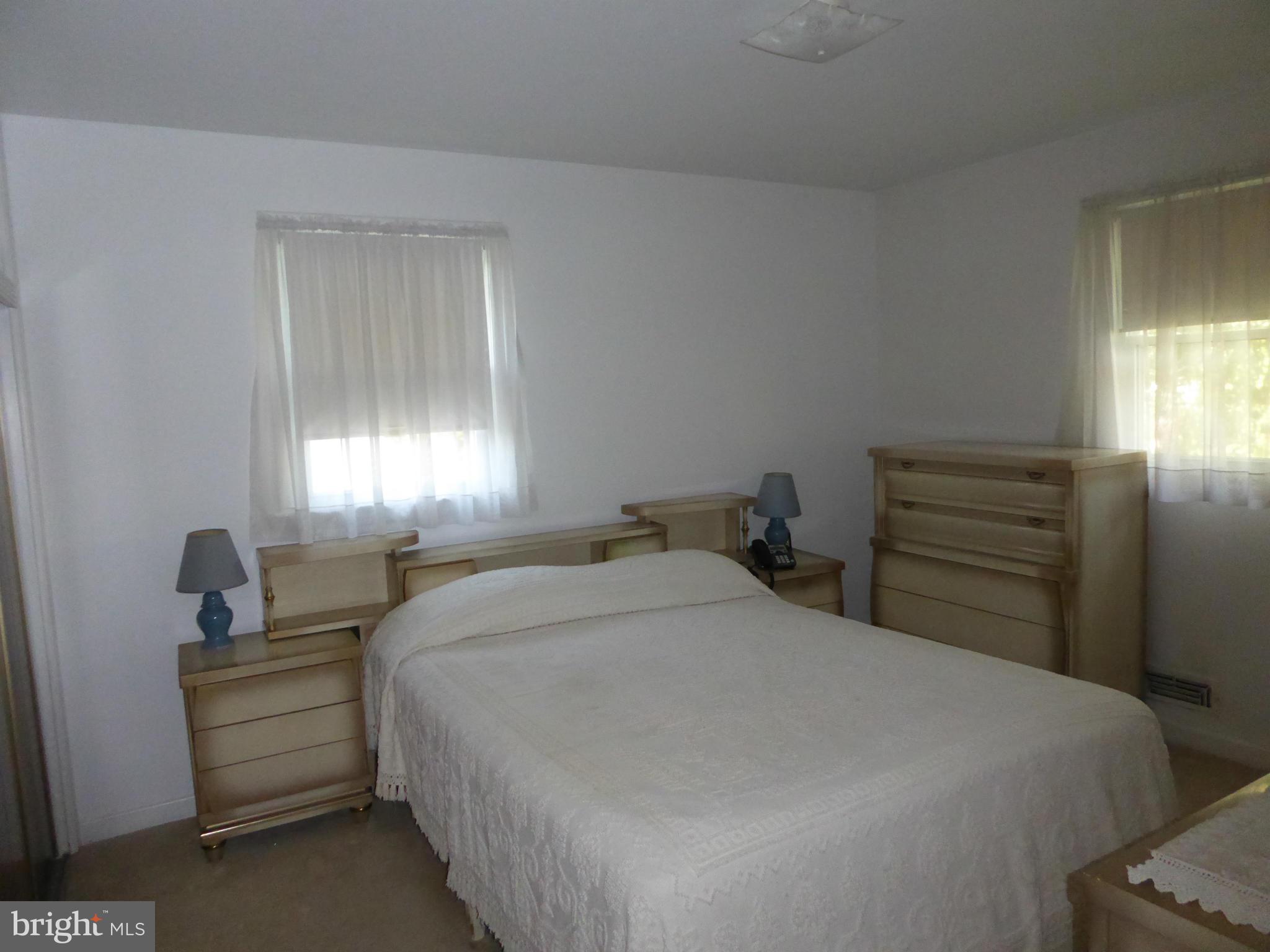 12907 Bluhill Road Silver Spring, MD 20906 - Photo 8 of 20 a bedroom with a bed and a window