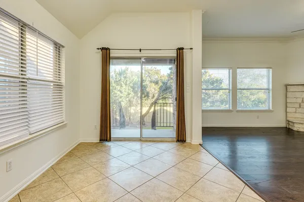a view of a room with wooden floor and large windows