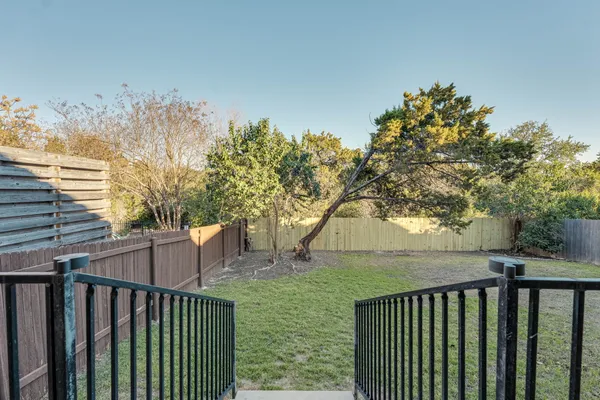 a view of a wooden deck next to a yard